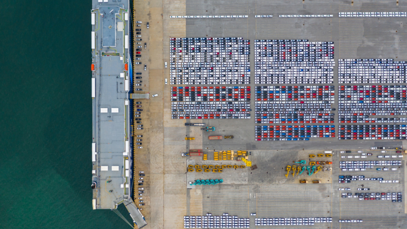 Aerial view of congestion at Australian port with shipping containers lined up alongside large vessel docked