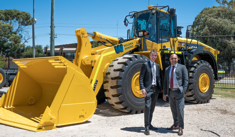 Neil Ferguson and Anthony Rechichi standing in front of a piece of equipment.